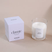 Amaraa Sweet Morning soy wax candle in glass jar with classic white packaging on beige background